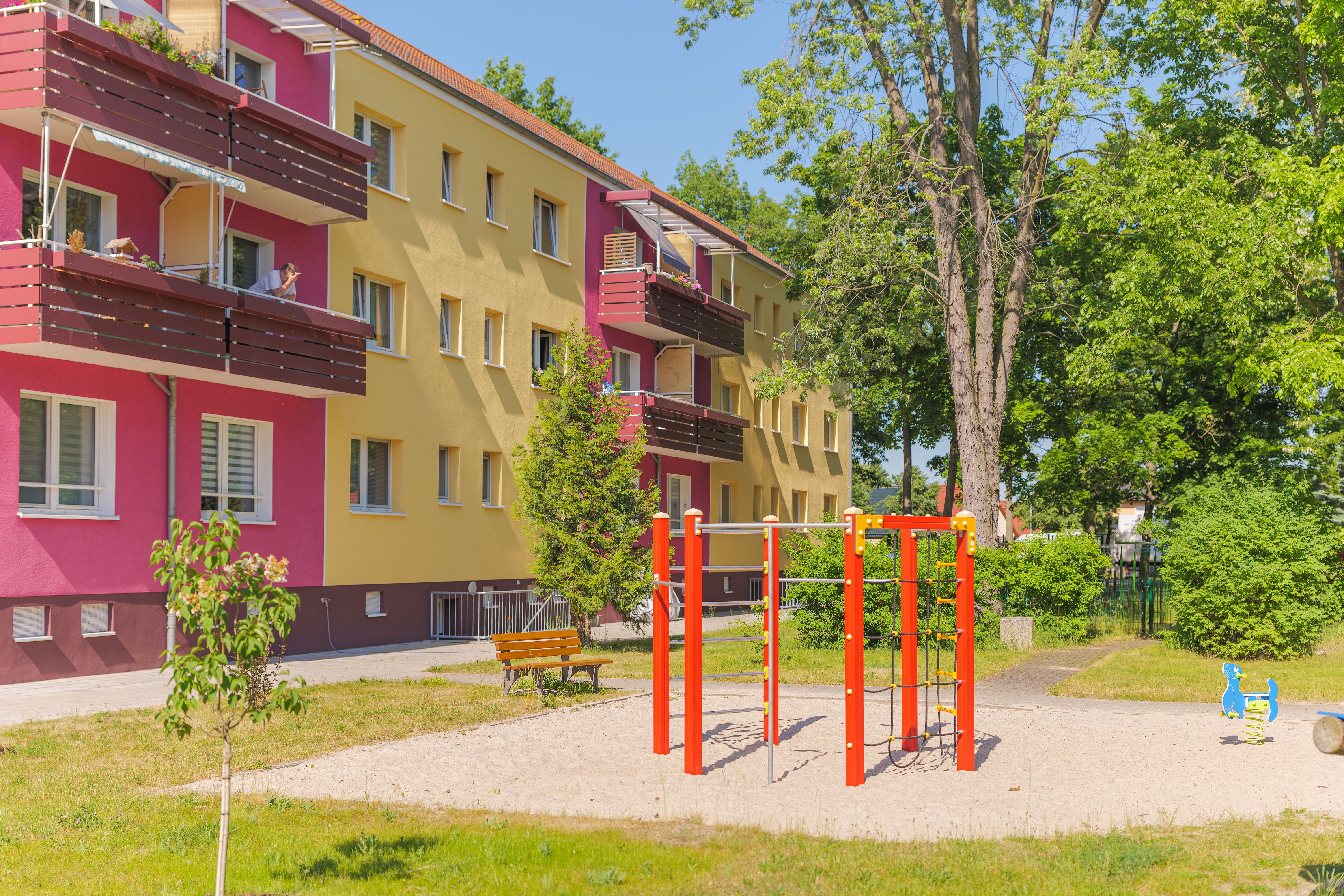 farbintensives Wohnhaus mit Spielplatz im grünen Hof